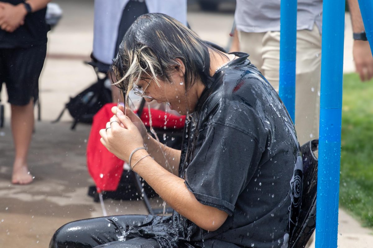 Cardin Nguyen, a cabinet member of the Asian Student Conference, is doused in water during the group's fundraiser. The Asian Student Conference aims to support Wichita State students and share Asian culture.
