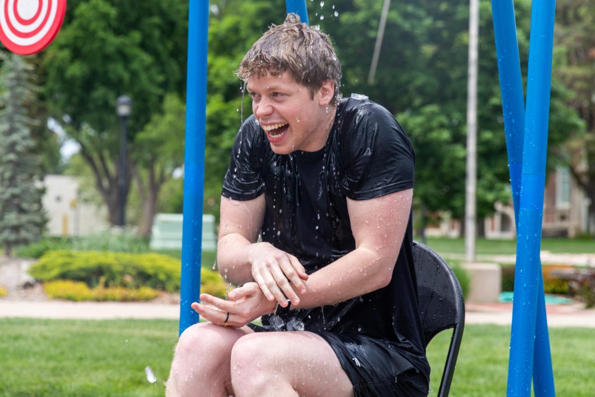 Logan Roberts laughs after being doused in water at the Asian Student Conference fundraiser outside the RSC on April 29. "This is torture," Roberts said.