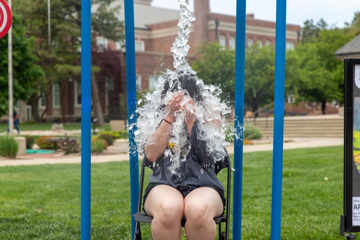 Lynn Tran, a second year health science student, is doused in water outside the Rhatigan Student Center. Tran participated in the Asian Student Conference's fundraiser on April 29.