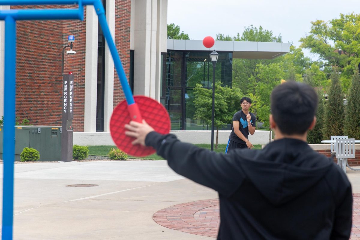 Jacob Inthirath, a member of the Asian Student Conference, throws a ball at the dunk tank target during the group's fundraiser outside the RSC. Students could pay $2 for one throw, $3 for two throws or $5 for a guaranteed dunk.