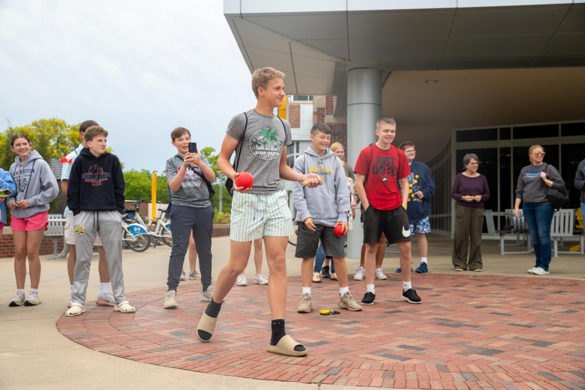A group of visiting students take turns throwing the ball for the last dunk of the day at the ASC fundraiser on April 29.