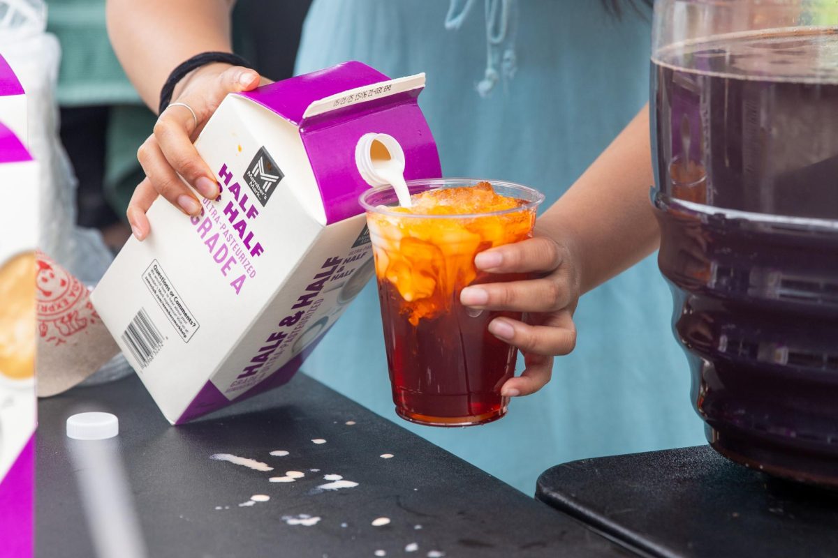 Amy Nguyen serves thai tea during the Asian Student Conference fundraiser on April 29. ASC sold Thai tea, Spam musubi and balls to dunk ASC cabinet members to raise money for the group.