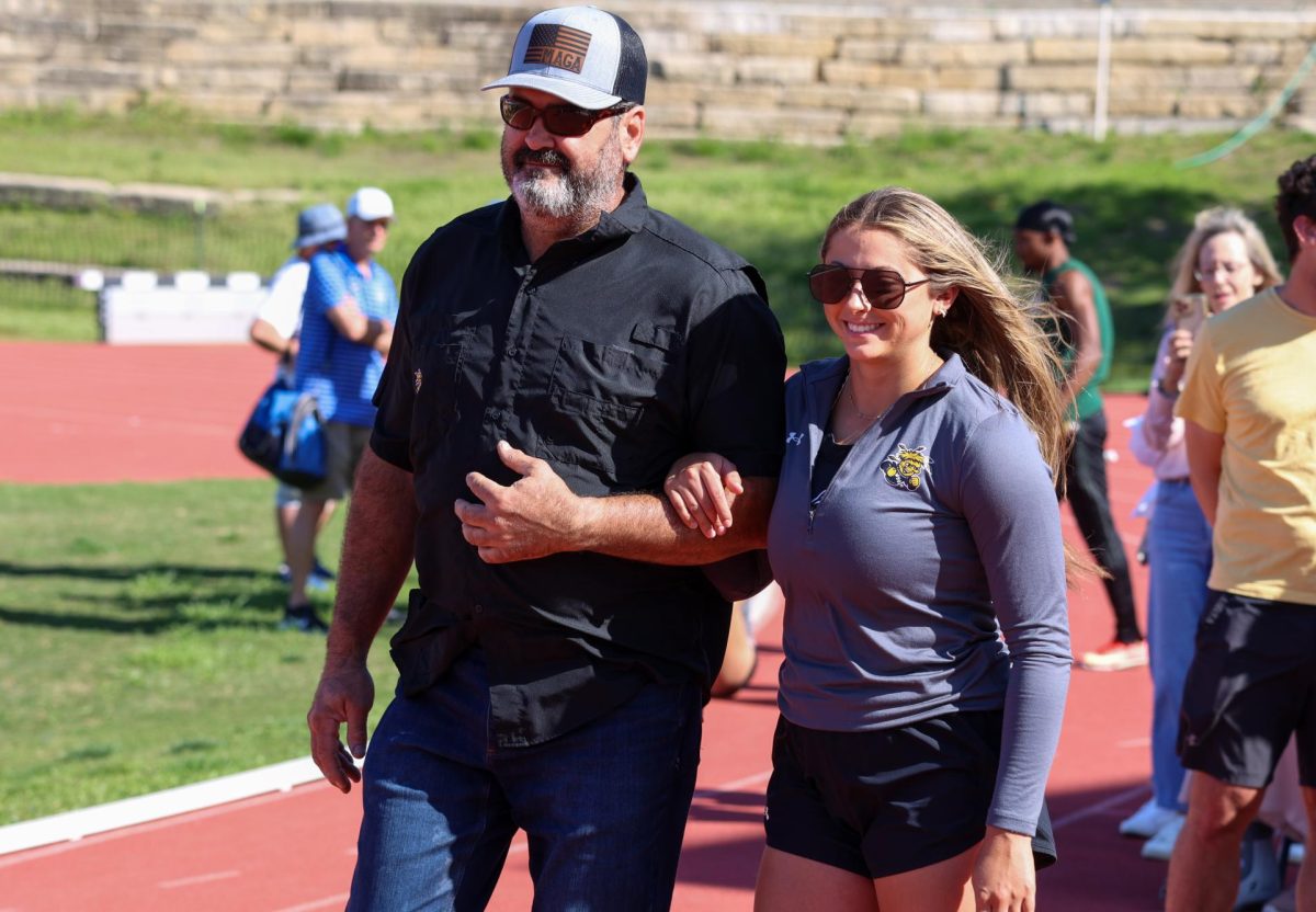 Senior Bailey Hartley walks out during the senior day celebration on May 9. Hartley placed seventh and eighth in the women's pole vault and 400-meter sprint, respectively, at the Shocker Open.