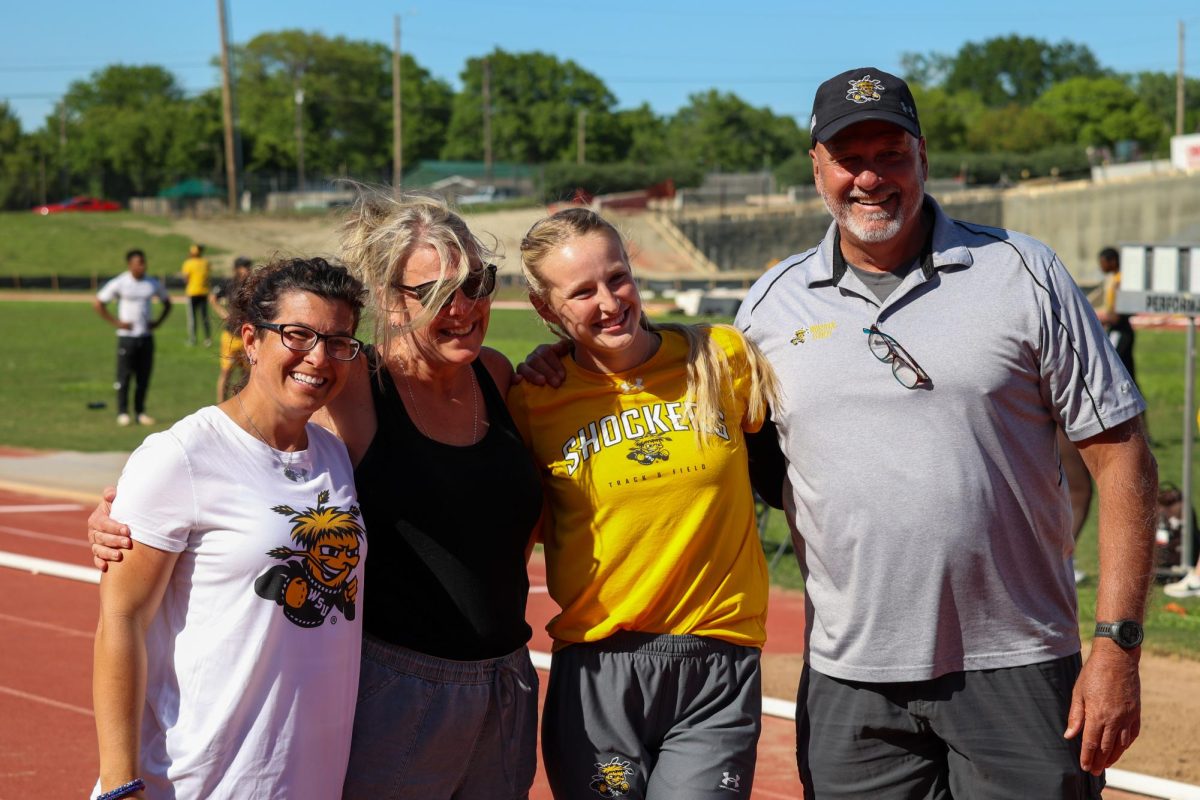 Senior Grace Lange takes a picture with Director of Track and Field Steve Rainbolt on May 9 during the senior day celebration. Lange has been named to the Academic All-American Athletic Conference team twice.