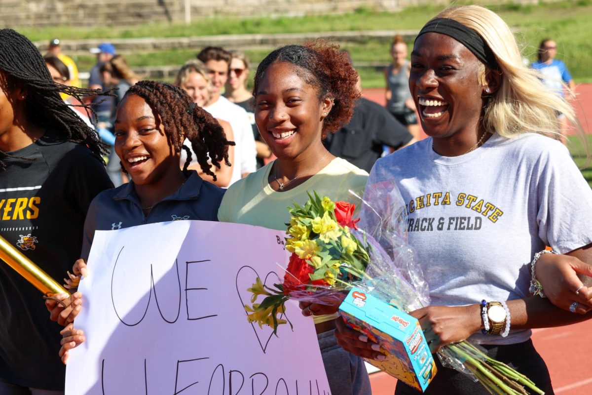 WSU senior Farrah Miller (right) walks during her senior day celebration at the Shocker Open. Miller has been named to the All-American Athletic Conference team four times for indoor and outdoor events.