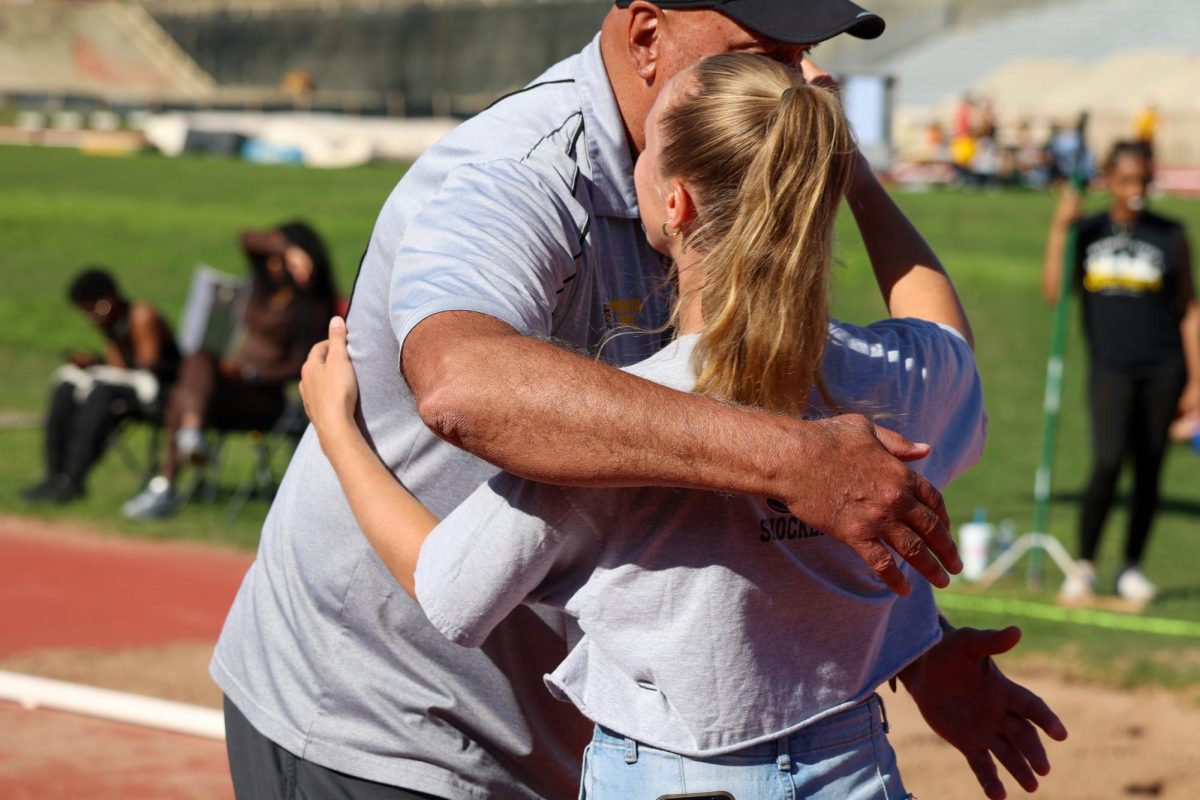 Senior Jenna Muma embraces WSU's Director of Track and Field Steve Rainbolt on May 9. Muma has spent her entire collegiate career as a Shocker.
