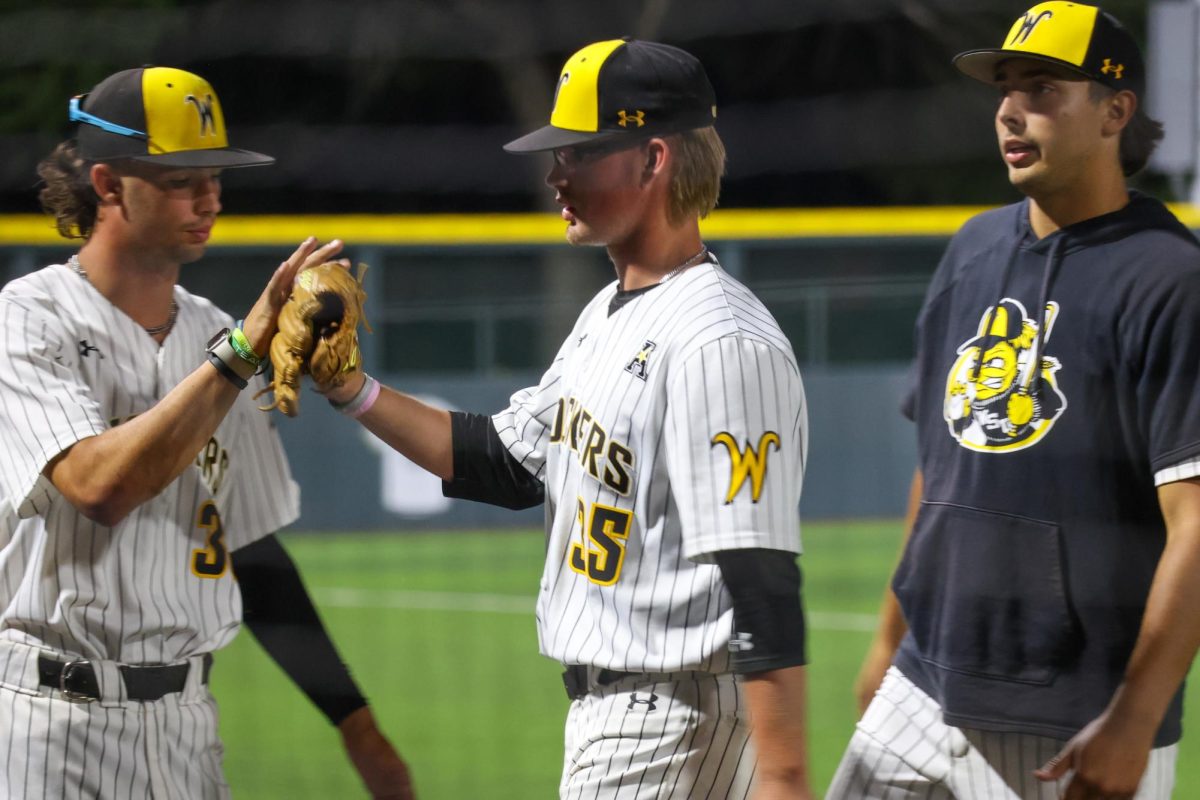 WSU's dugout welcomes sophomore Drew Iverson after he was pulled from the mound on May 13. The Shockers used seven pitchers in the 13-9 win against Oral Roberts.