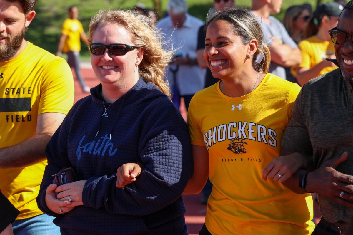 Senior Faith Turner (middle right) smiles while walking out during the senior day celebration on May 9. Turner did not compete during the Shocker Open.