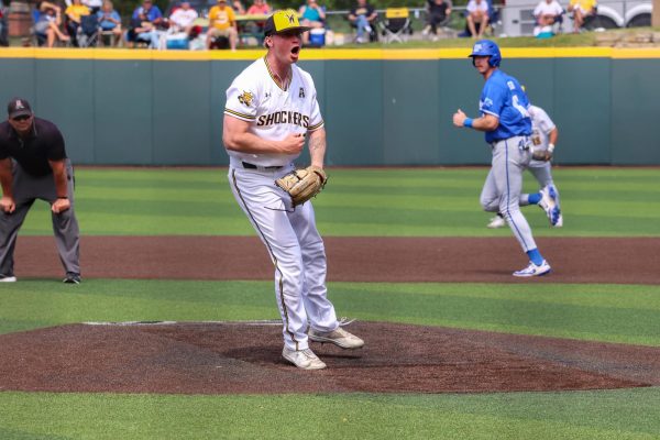 Senior Jack Mount screams after striking a Tigers hitter to strand the bases loaded in the eighth inning. The Shockers beat Memphis, 3-1, on May 17.
