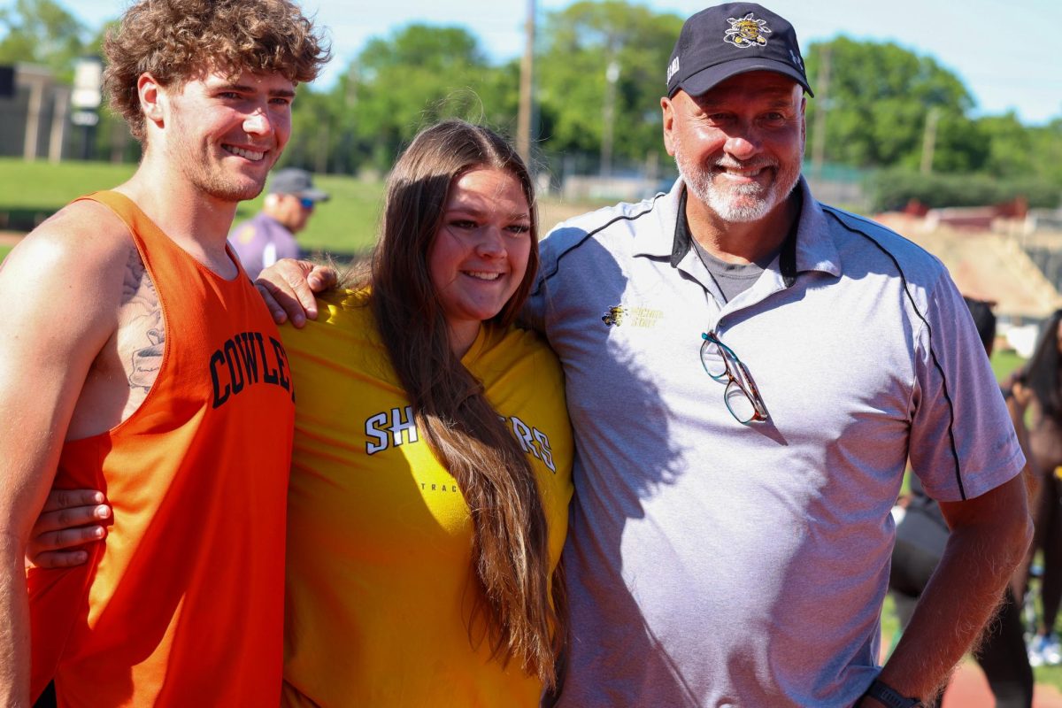 Senior Kylie Zimmer takes a picture with WSU's Director of Track and Field Steve Rainbolt at the Shocker Open on May 9. Zimmer was recognized during WSU's senior day celebration.