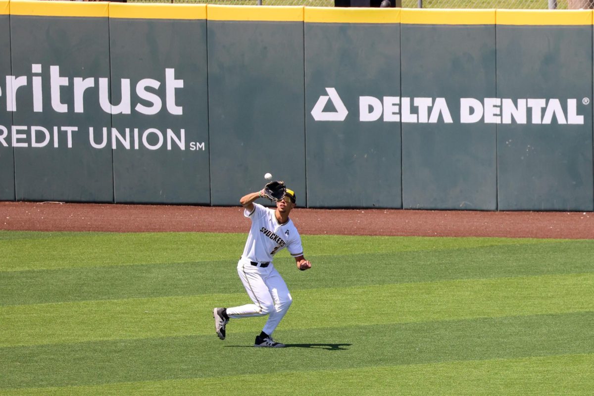 Junior Jaden Gustafson catches a ball in the outfield on May 17. Gustafson has not committed an error in 43 starts this year.