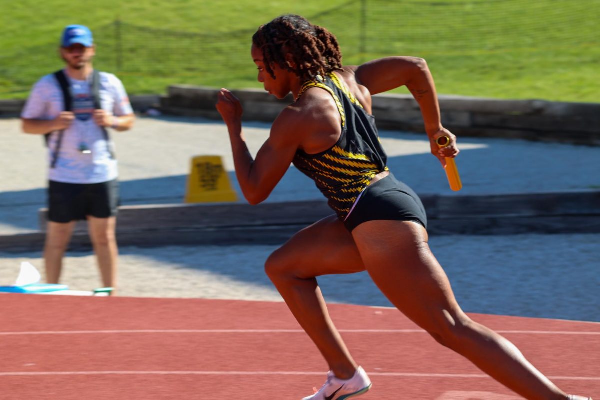 Junior Courtney Wilborn sprints after hearing the starting gun during the women's 4x100 relay. Wilborn ran the first leg of the race and WSU's team won with a time of 45.92.