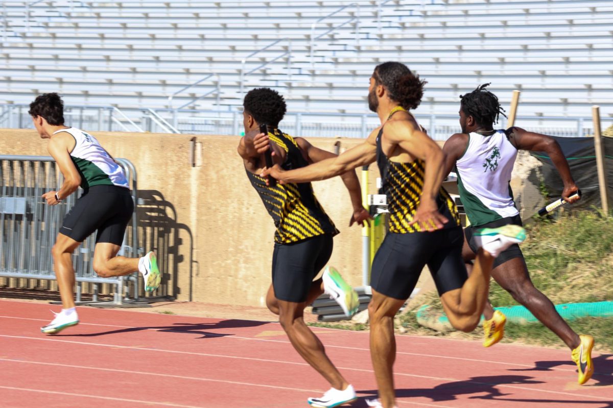 Senior Joakim Genereux passes baton to sophomore Jason Parrish during the men's 4x100 relay at the Shocker Open on May 9. The Shockers won the event with a time of 40.43.
