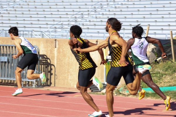 Senior Joakim Genereux passes baton to sophomore Jason Parrish during the men's 4x100 relay at the Shocker Open on May 9. The Shockers won the event with a time of 40.43.