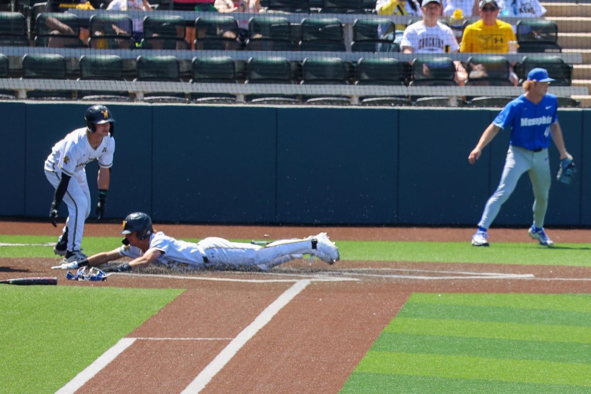 Sophomore Camden Johnson slides headfirst into home plate on May 17. Johnson leads the Shockers in runs scored and hits with 46 and 72, respectively.