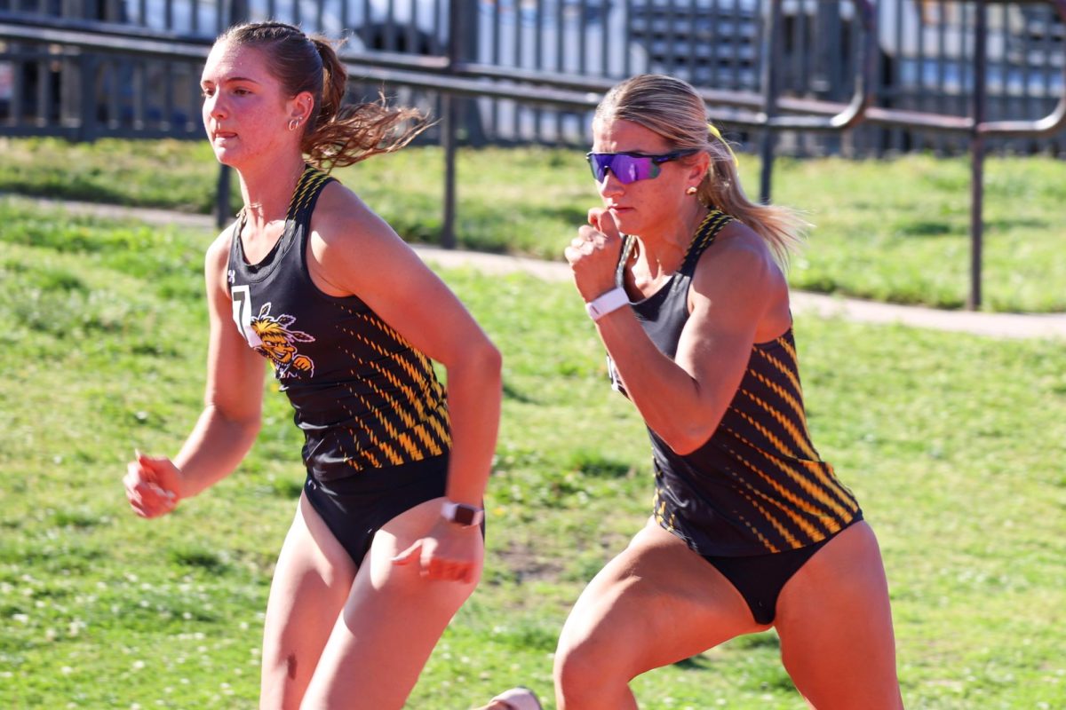 Freshman Natalie Hill and junior Brianna Utecht sprints after the starting gun was fired during the women's 100-meter hurdles at the Shocker Open on May 9. Hill and Utecht finished in eighth and fourth, respectively.