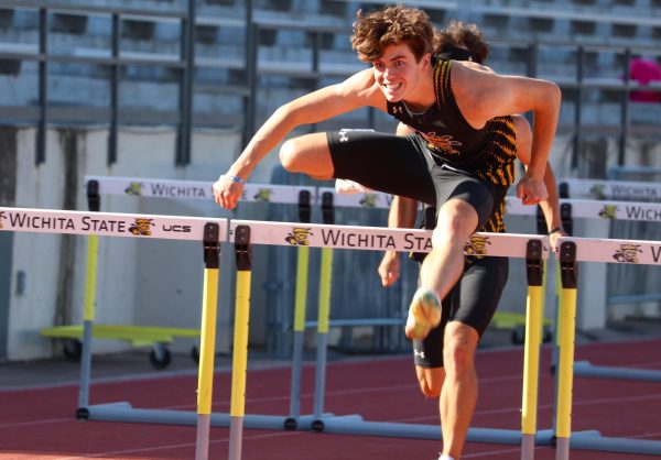 Sophomore Tyler Carroll jumps over a hurdle on May 9. Carroll finished the men's 110-meter hurdles in first place, with a time of 14.01 at the Shocker Open.