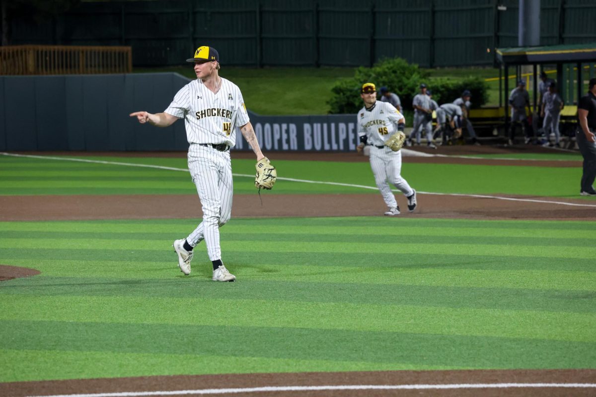 Senior Jack Mount points to the Shockers' dugout after he strikes out the final batter of the game on May 13. This was Mount's only strikeout in the 13-9 win against Oral Roberts.