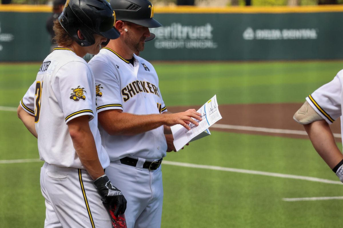 Sophomore Gannon Snyder and Director of Operations Tad Reida look at the scouting report on May 17. Snyder hit 2-for-3 in the 3-1 win against Memphis.