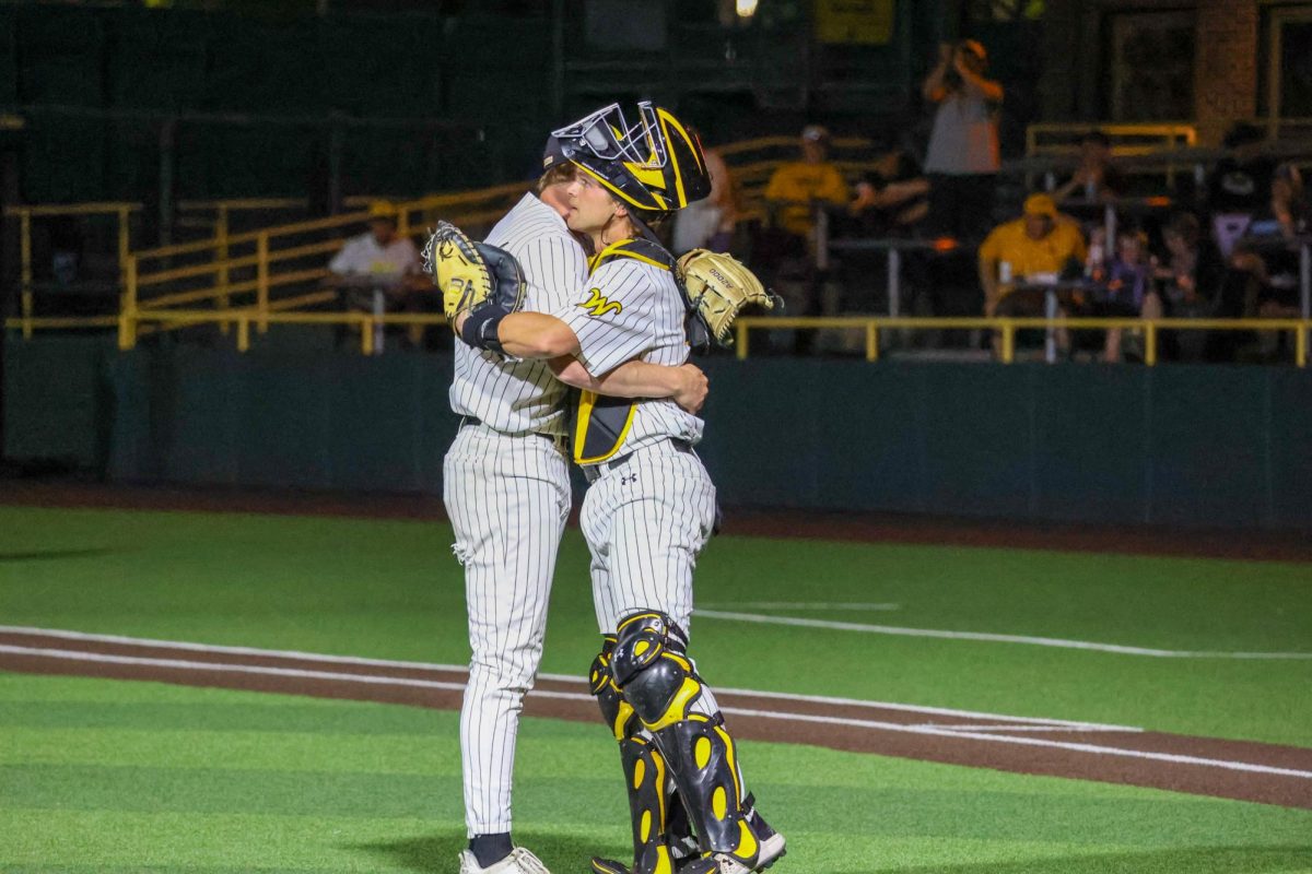 Seniors Jack Mount and Cole Dillon hug at the end of a 13-9 win on May 13. Mount pitched the final two innings for the Shockers against Oral Roberts.