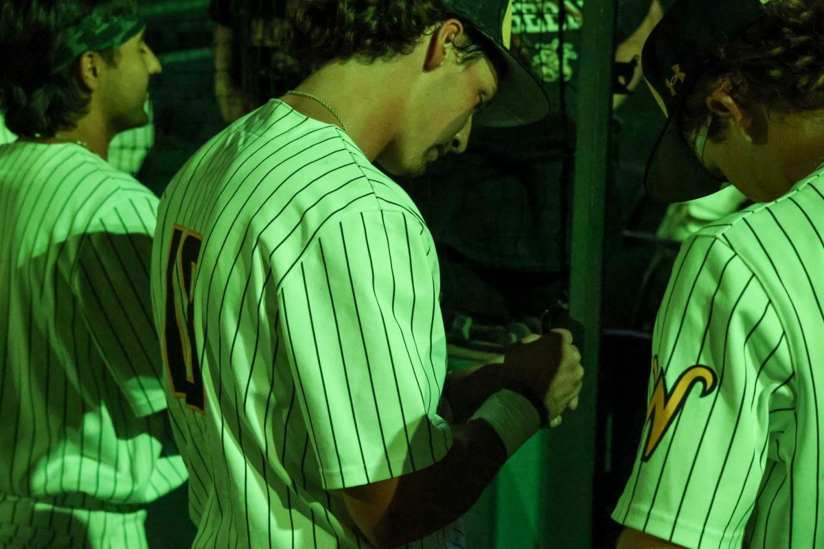 Senior Jordan Rogers autographs a WSU fan's ball after the game on May 13. Rogers hit 1-3 in the 13-9 win against Oral Roberts.
