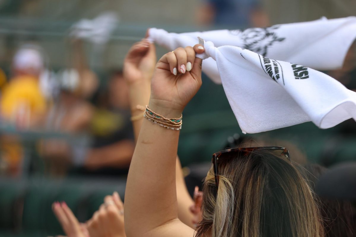 Shocker fans wave rally towels during the ninth inning on May 17. The Shockers swept Memphis in a three-game series to end the regular season.