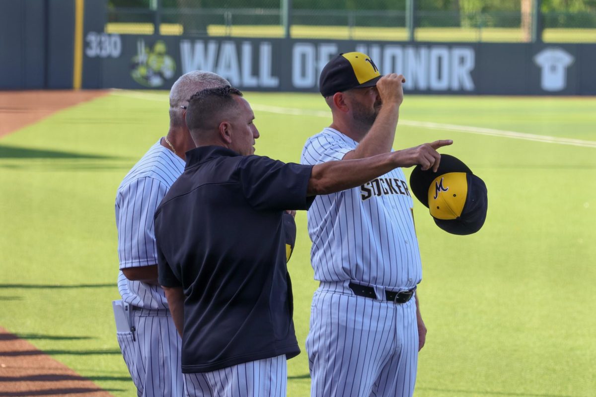WSU head coach Brian Green points something out to his assistant coaches on May 13. Green is in his second year as the Shockers' head coach.