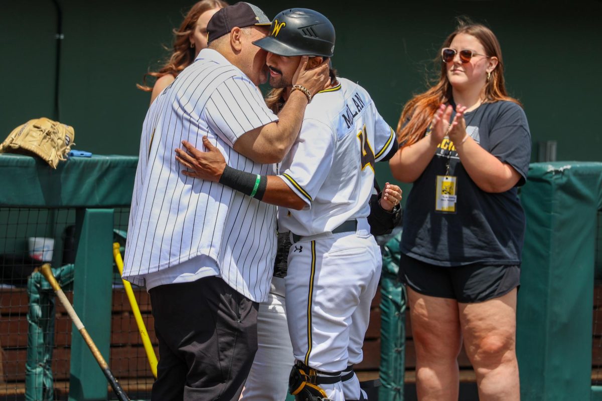 Senior Mauricio Millan hugs a family member after he is announced on WSU baseball's senior day. Millan hit 1-for-4 in his final game at Eck Stadium against Memphis on May 17.