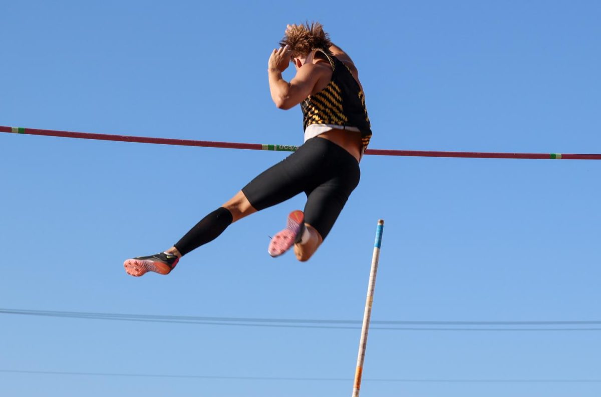 Freshman Carson Ratzlaff successfully clears the bar in the men's pole vault at the Shocker Open on May 9. Ratzlaff finished in third with a mark of 4.43 meters.