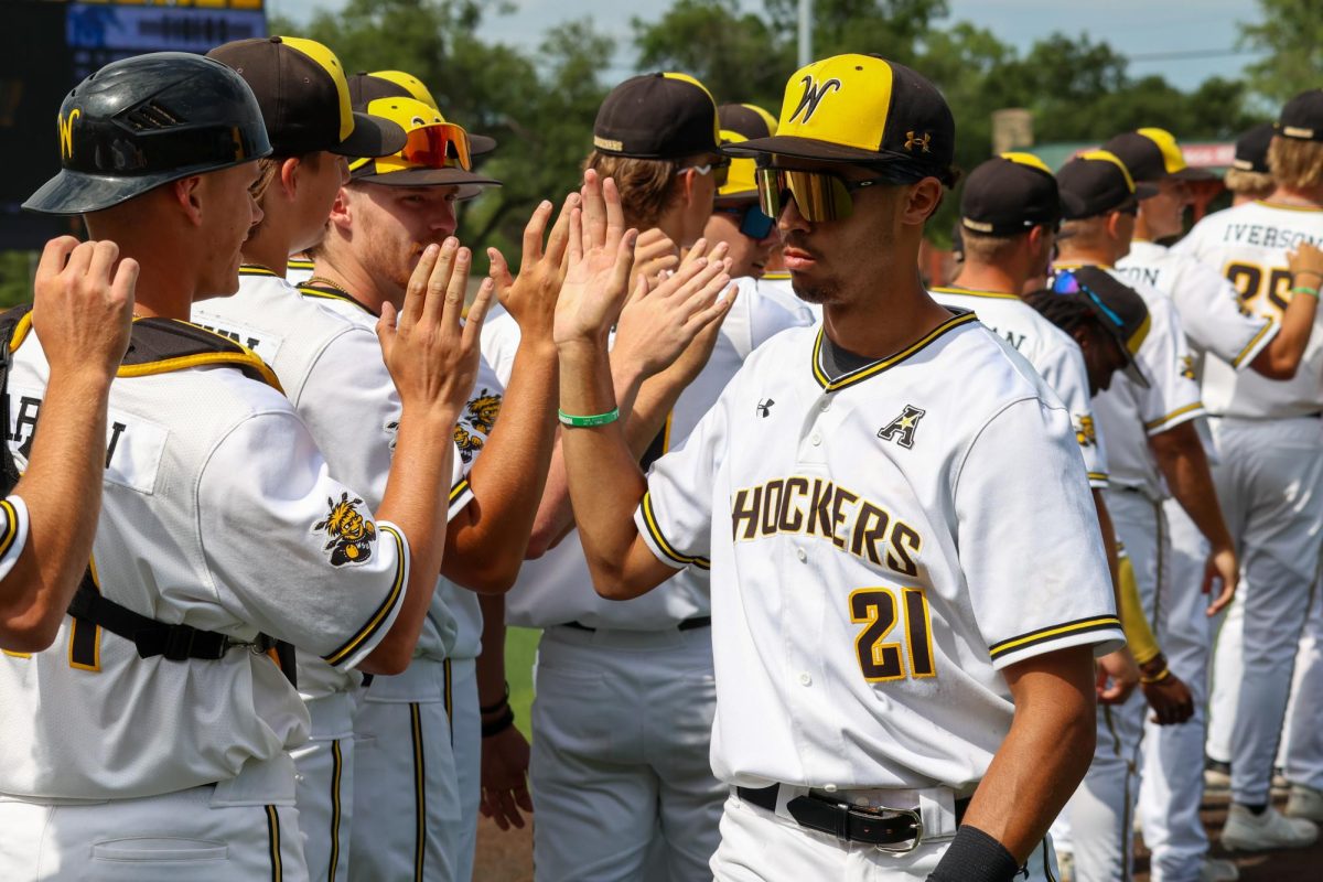 Junior Jaden Gustafson high-fives his teammates after the 3-1 win against Memphis on May 17. Gustafson hit 1-for-4 during the game.