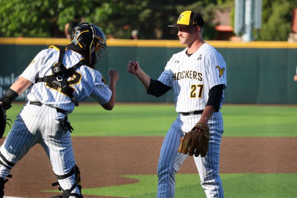 Senior Cole Dillon fist bumps junior Caleb Anderson after an inning. The Shockers beat Oral Roberts, 13-9, on May 13.