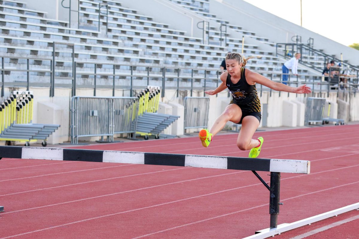 Freshman Emily See jumps over a barrier during the women's 3,000-meter steeplechase at the Shocker Open. See finished in second placed on May 9.