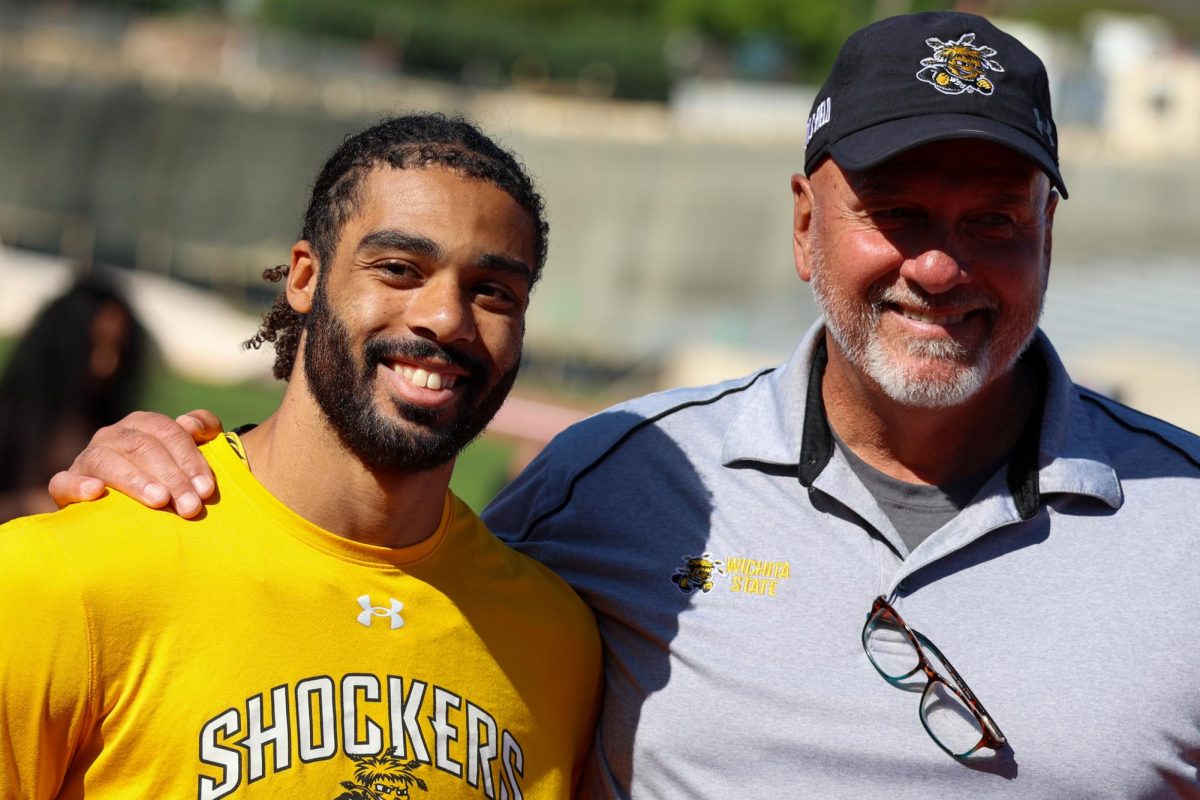 Senior sprinter Joakim Genereux takes a picture with WSU's Director of Track and Field Steve Rainbolt at the Shocker Open on May 9. Genereux has been named to the All-American Athletic Conference team seven times for indoor and outdoor events.