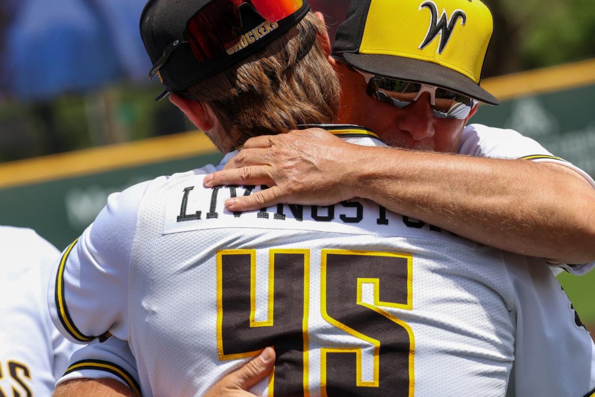 Senior Josh Livingston hugs WSU's 
Catching Coach and Recruiting Coordinator Clay Overcash during the senior day celebration on May 17. Livingston hit 2-for-4 with two RBI in the 3-1 win against Memphis.