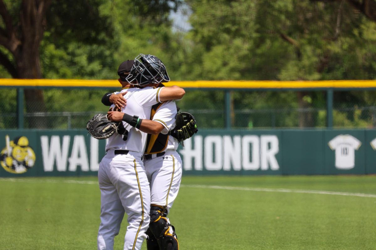 Senior Mauricio Millan hugs sophomore Kaleb Duncan before they take the field against Memphis. Millan hugged every teammate who started in the 3-1 win on May 17.