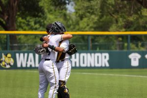 Senior Mauricio Millan hugs sophomore Kaleb Duncan before they take the field against Memphis. Millan hugged every teammate who started in the 3-1 win on May 17.