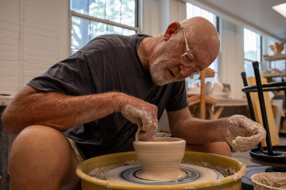 Rick Mullen shows how to make a bowl at the Build-A-Bowl for Empty Bowls event on June 18. Mullen The annual event took place at the Henrion Hall.
