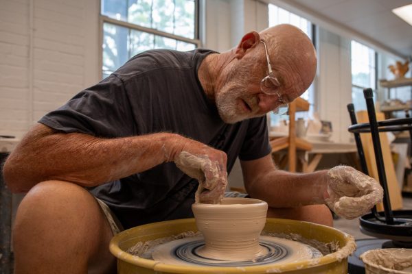 Rick Mullen shows how to make a bowl at the Build-A-Bowl for Empty Bowls event on June 18. Mullen The annual event took place at the Henrion Hall.