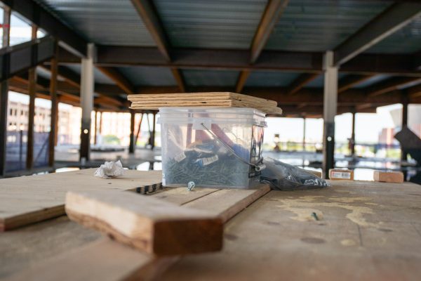 Plywood sits on a box of screws in the construction site of a new combined biomedical campus. The campus will combine program from WSU’s College of Health Professions, WSU Tech and KU and is expected to be fully operation in the summer of 2027.