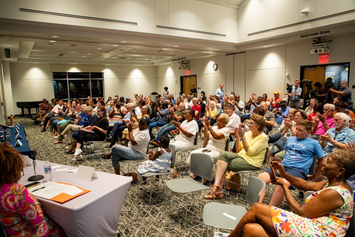 Audience members applaud the District One City Council candidates at the end of the forum hosted on July 15. More than 200 people attended the forum, with more watching on a livestream.