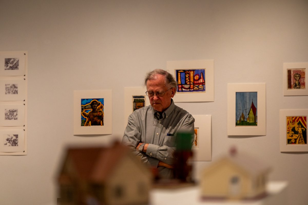 Jim looks at Clark Britton's art on Aug 7. Britton's art is currently exhibited at the Clayton Staples Gallery.
