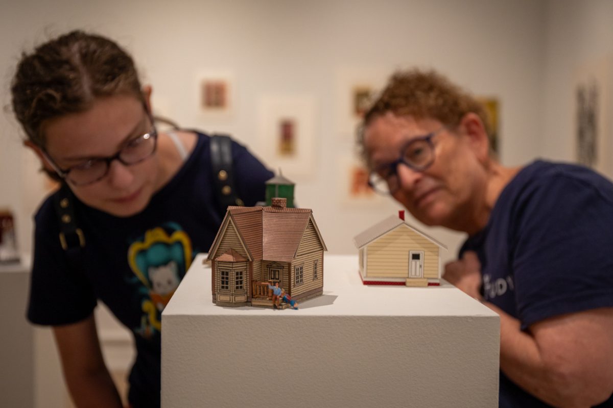 Sara Farley and granddaughter look at Clark Britton's art on Aug 7. The exhibiton is held at Clayton Staples Gallery.