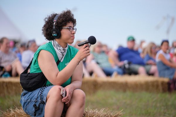 Editor-in-Chief Taliyah Winn records audio at the Flint Hills Symphony. Photo Courtesy of Grant Seymour/ The Flint Hills Media Project