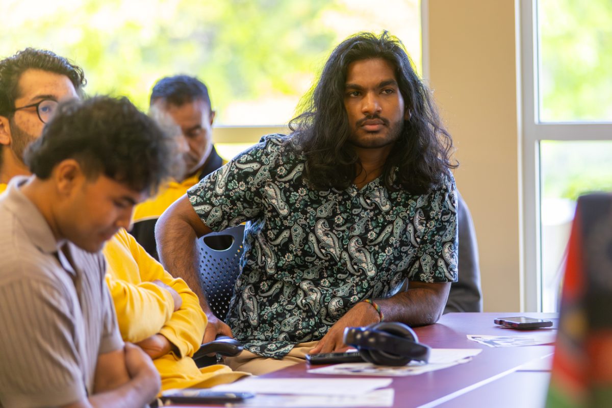 Dion Samuels listens as other ISU executive position candidates make their pitches during the group's May election meeting. Samuels won the presidential vote, but the results were later overturned.