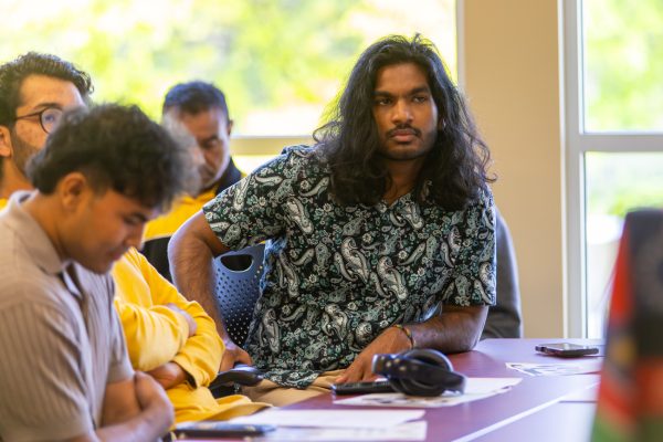 Dion Samuels listens as other ISU executive position candidates make their pitches during the group's May election meeting. Samuels won the presidential vote, but the results were later overturned.