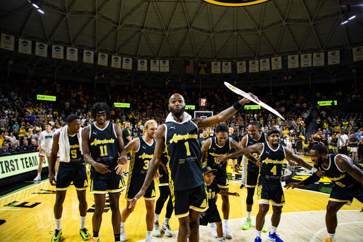 AfterShocks forward Markis McDuffie leads the team in the "McDuffie Slide" to celebrate their win over We Are D3 on July 31. The Aftershocks bench outscored the We Are D3 bench 38-14.