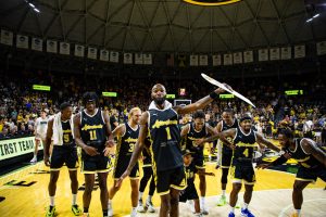 AfterShocks forward Markis McDuffie leads the team in the "McDuffie Slide" to celebrate their win over We Are D3 on July 31. The Aftershocks bench outscored the We Are D3 bench 38-14.