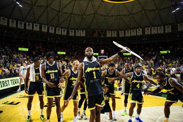 AfterShocks forward Markis McDuffie leads the team in the "McDuffie Slide" to celebrate their win over We Are D3 on July 31. The Aftershocks bench outscored the We Are D3 bench 38-14.