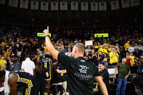 AfterShocks head coach Zach Bush holds up one finger to the crowd as he walks into the tunnel on July 31. With the win, the AfterShocks became the first alumni team in TBT history to host the championship game on its home court.