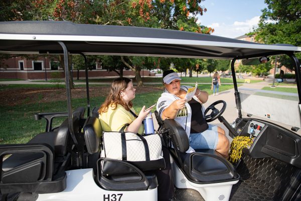 Alicia Newell shows freshman Cloie Burris where her classes are on a map after driving her to Hubbard Hall.